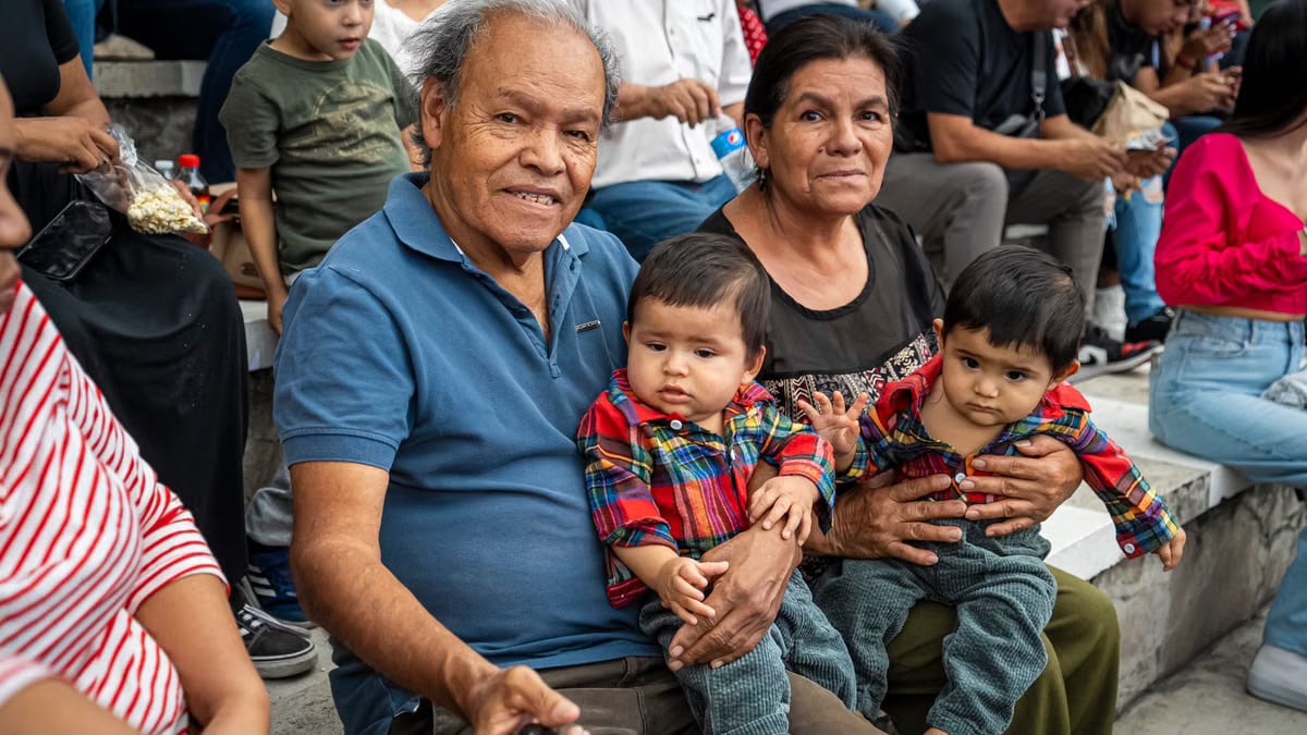 A joyful family moment captured with grandparents and grandchildren enjoying an outdoor gathering.